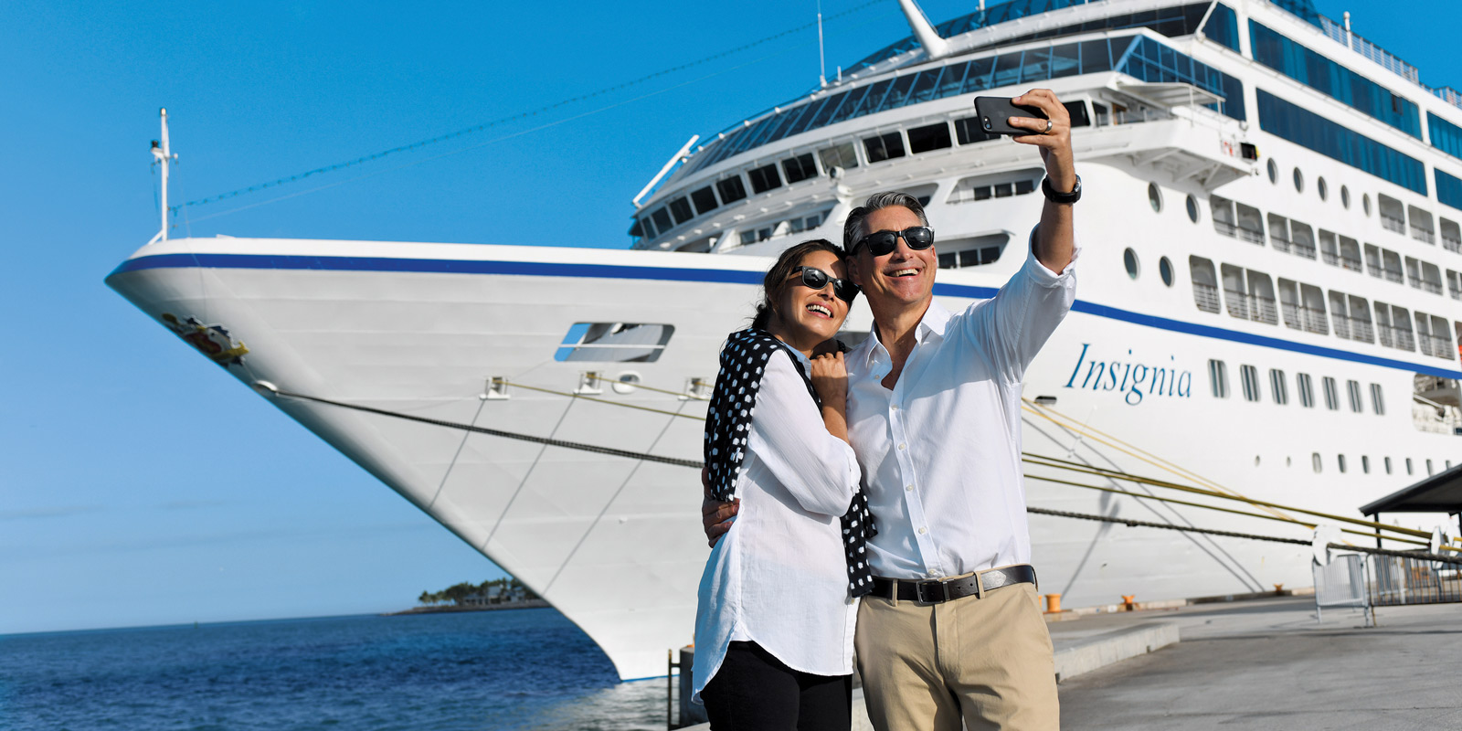 Förväntansfulla gäster framför Oceania Cruises fartyg Insignia.